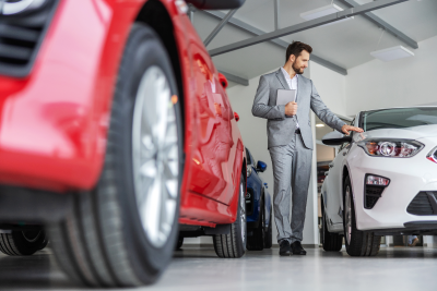 Dealer Reviewing Used Car for Purchase